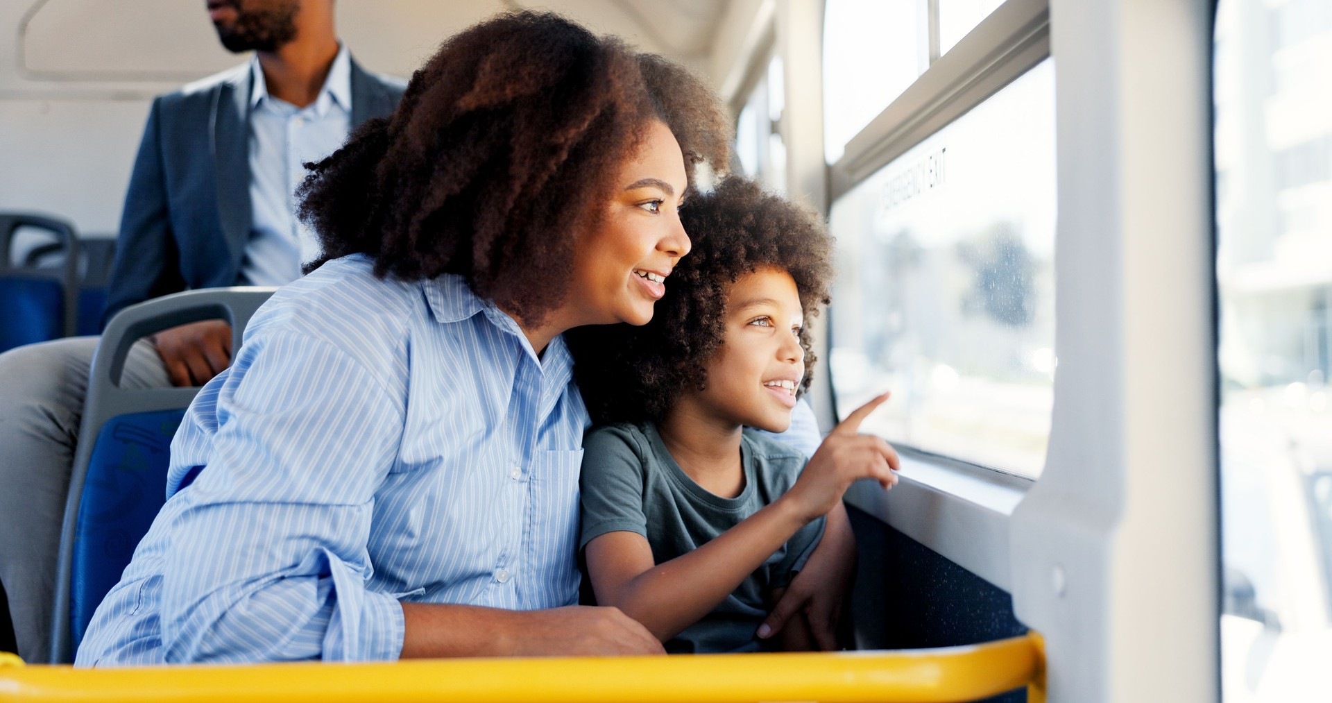 Talking, bus or travel with mom, kid or smile for commute on urban journey, holiday or trip. Mother, window or boy child with parent in city for sightseeing, public transport or morning adventure