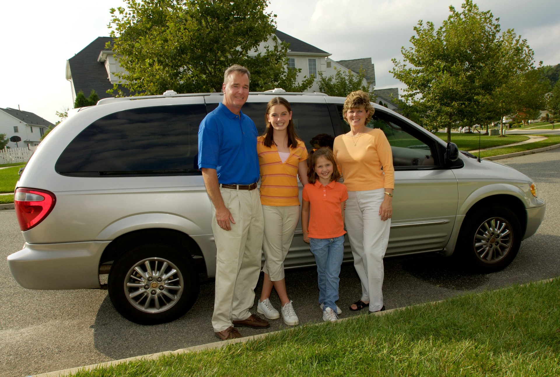 family of four with minivan