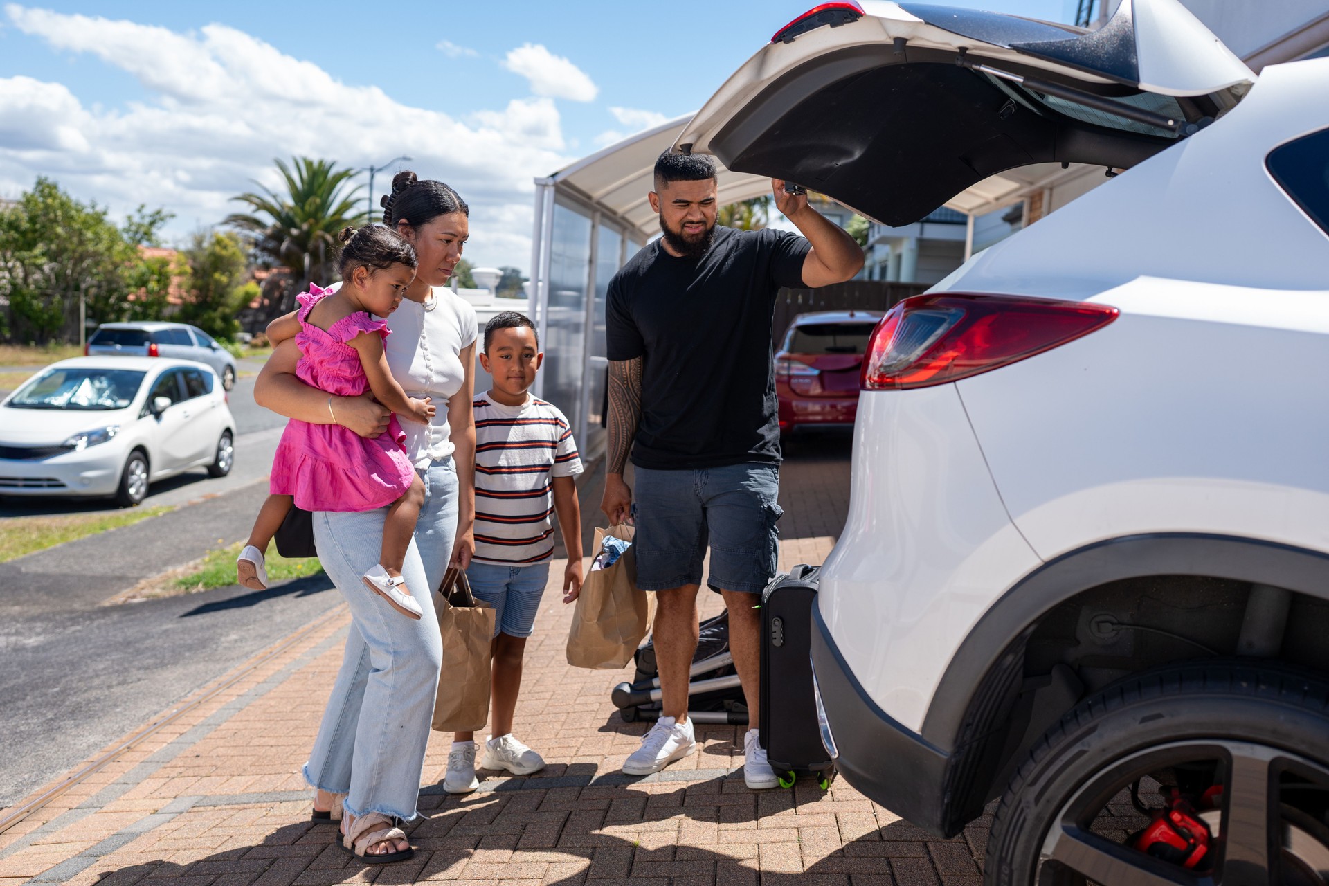 Pacific Islander Family Unpacking Car