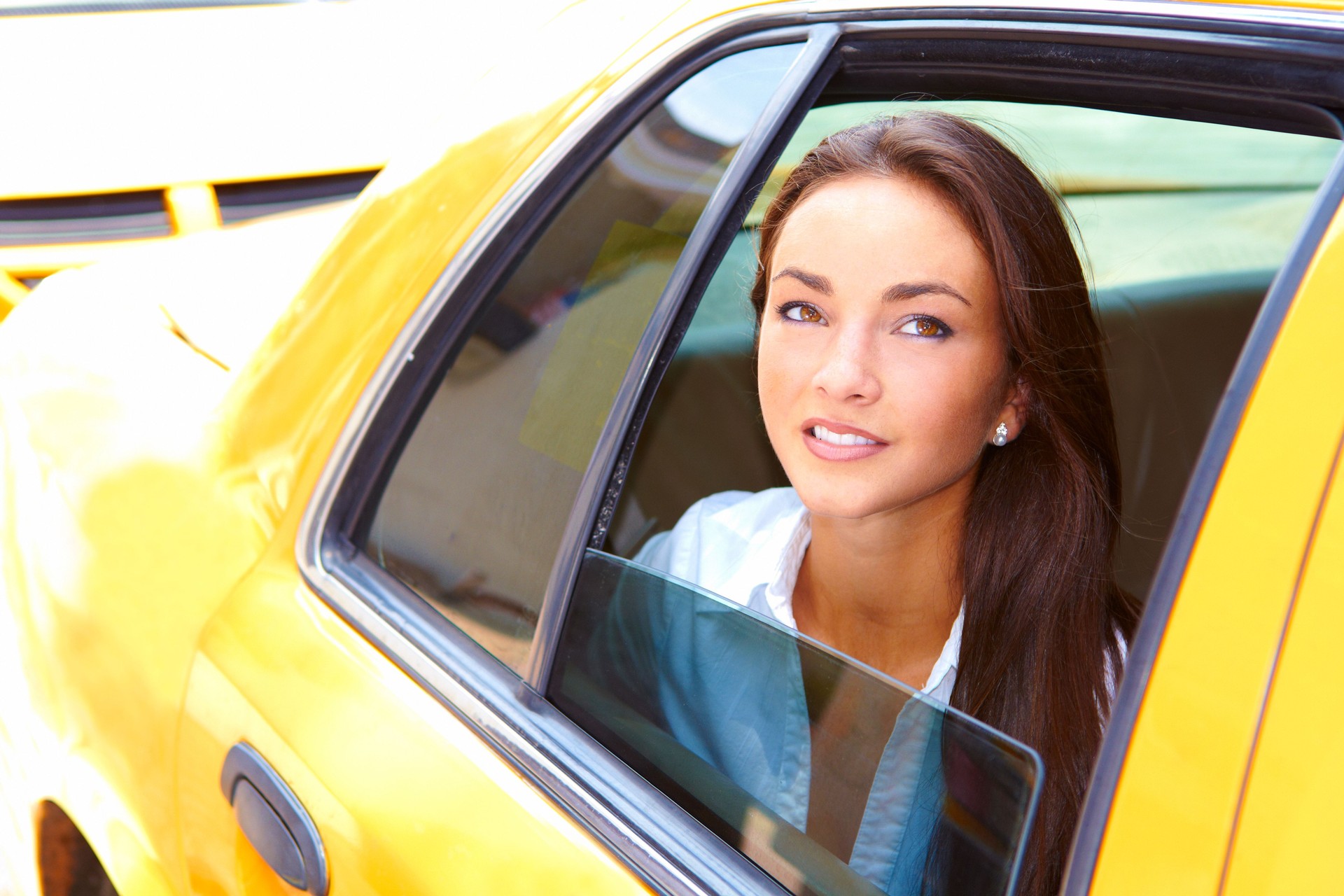 beautiful young business female riding in taxi